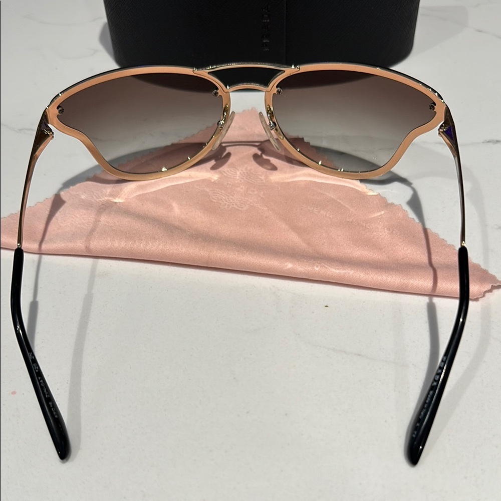 Prada PR74VS sunglasses butterfly silhouette with a metallic gold frame. - Picture 7 of 12